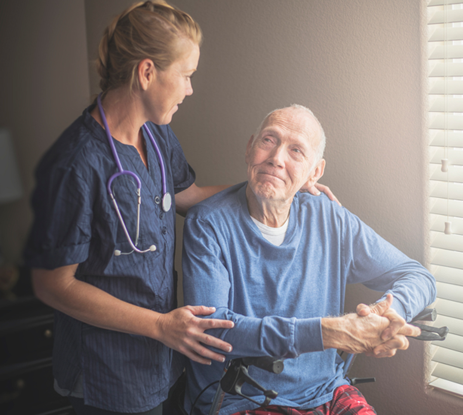 Female-hospice-nurse-taking-care-of-elderly-male-patient