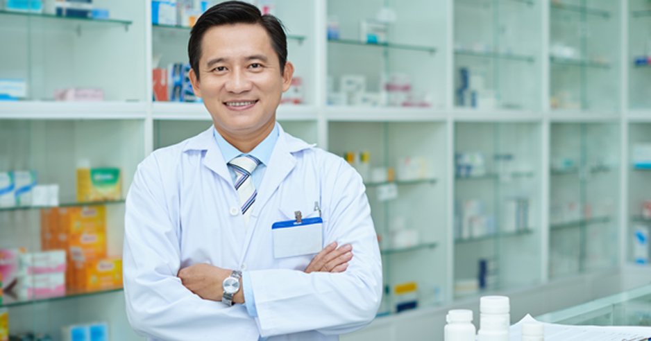 Male-pharmacist-smiling-at-a-hospice-pharmacy-in-Burbank