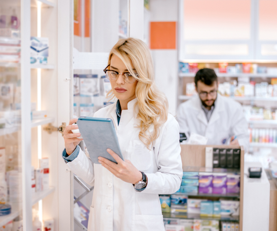 Pharmacist-at-a-hospice-pharmacy-in-Beverly-Hills-reviewing-list-of-medications-on-a-tablet